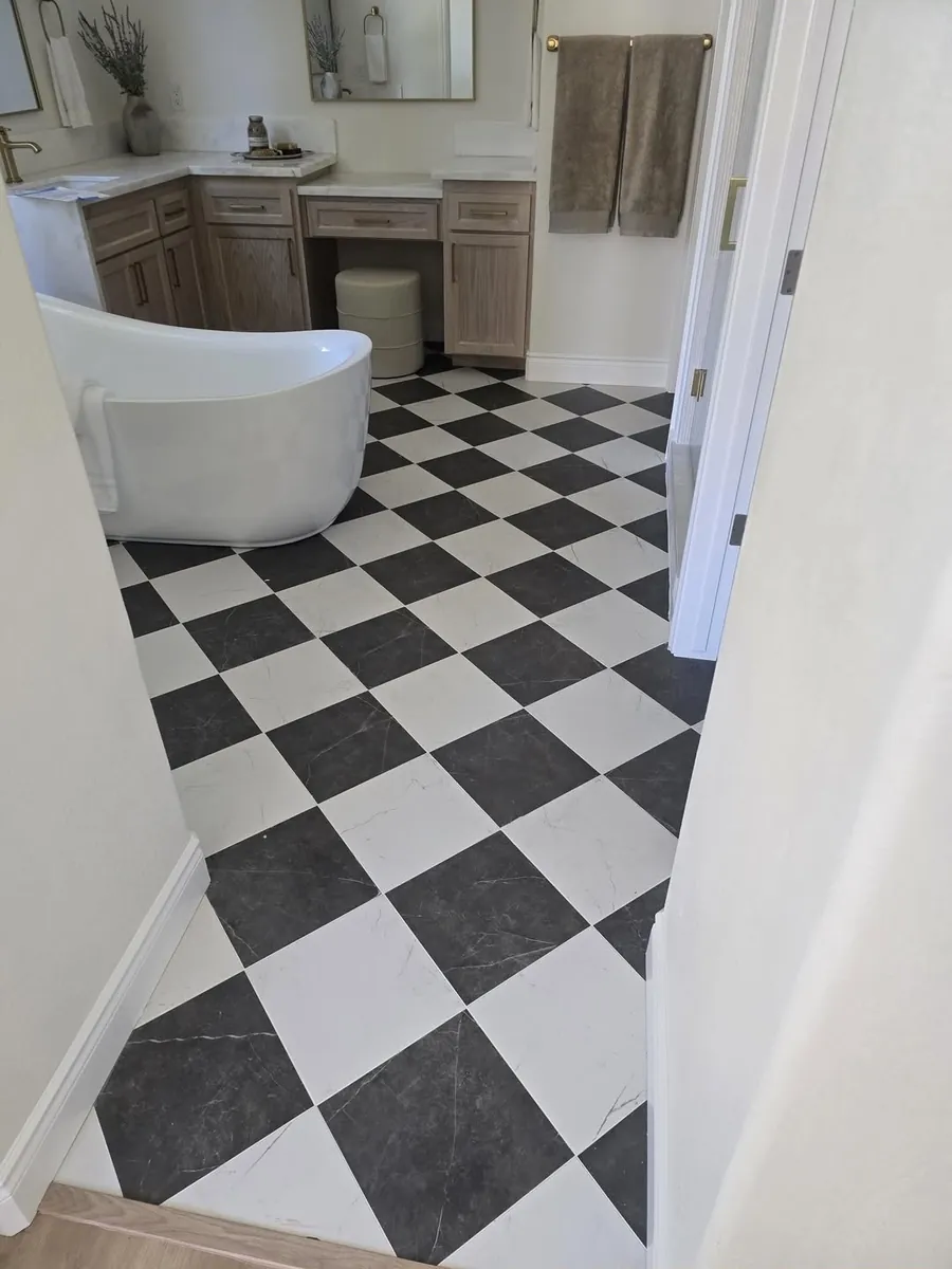 Checkerboard marble bathroom floor with freestanding tub