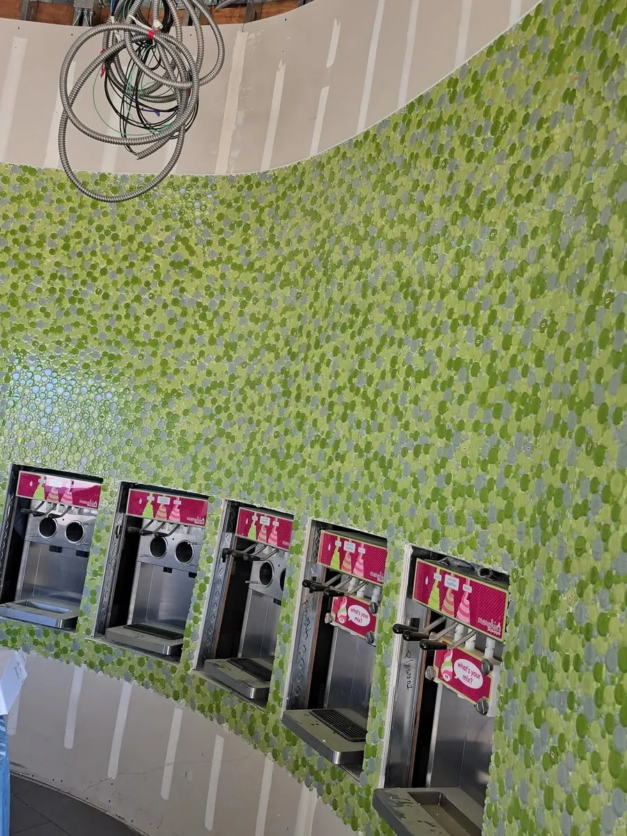 Curved commercial feature wall in green glass mosaic tile