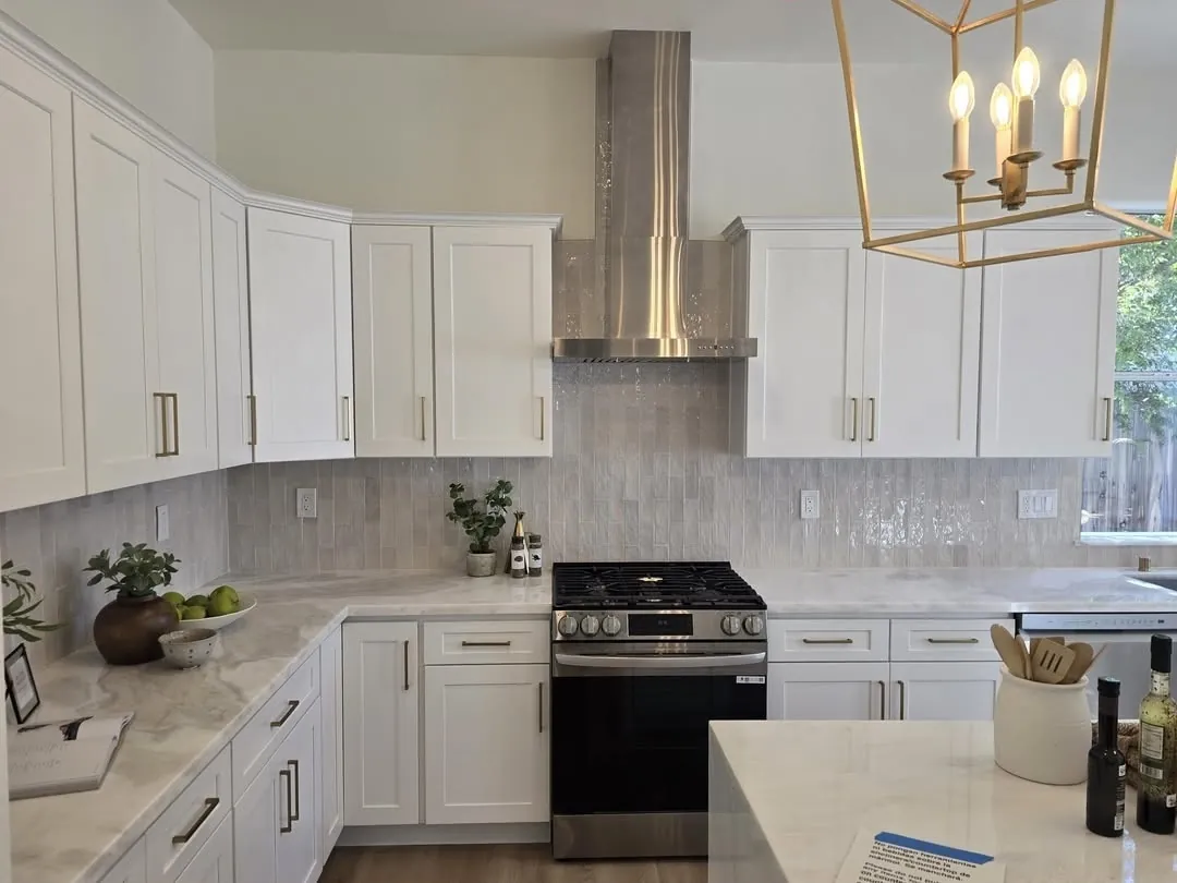 Finished kitchen with stacked stone backsplash and gold pendant
